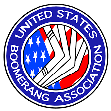 Logo for the United States Boomerang Association featuring white boomerangs over an American flag background, encircled by blue rings with the organizations name in white text.